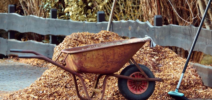 Wheelbarrow next to a Mulch Pile